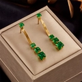 Elegant gold drop earrings with tiered emerald square stones on snake chain dangles - Green