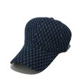 Detail of dark blue denim baseball cap showing textured woven dot pattern and fabric - Navy Blue