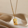 Macro shot of 18K gold plated hammered texture pendant with zircon on champagne silk - Hammered Sunburst Rhinestone Plate (G111407269)