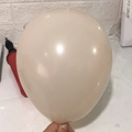 Single matte cream white 10 inch thick balloon held by hand for party decoration - Sand White