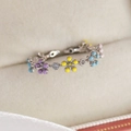 Close-up of macaron flower ring with colorful enamel petals and sparkling zircon stones - Seven-Color Flower (Silver Base)