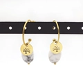 Detail of tree of life earrings with white marble teardrop charms on a display stand - Marble White (Style 7)