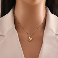 Golden balloon style initial Y pendant necklace with bead chain on a minimalist beige blazer - Letter Y