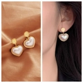 Golden heart pearl earrings with Love engraving on silk background and model shot - 17# Heart Engraved Pearl