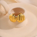 Elegant gold fan-shaped stud earrings with shell texture on ceramic display stand - Striped Shell