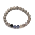 Macro shot of solar system bracelet with eight natural stone beads on white background - Pluto