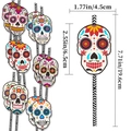 Biodegradable paper straws with colorful Day of the Dead skull toppers and striped pattern - Set of 12