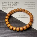 Bracelet en perles de bois brun en forme de tonneau avec veinage naturel sur papier - Bois de Santal Doré 7x8mm