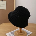 Chic black knitted bucket hat for women with ribbed texture on a wooden stand - Adjustable / Black