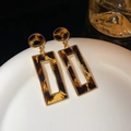 Detail view of retro leopard print drop earrings with gold metal frames on white plate - 9# Silver Needle Geometric Hollow Leopard Stud
