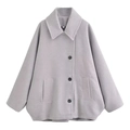 Close-up of a grey wool coat with lapel collar, single-breasted buttons, and flap pockets - XS / Gray