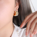 Golden C-shaped hoop earrings with two rows of white pearls and green gemstone accents - F909 Green Rhinestone Earrings
