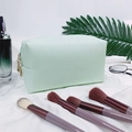 Light green crossgrain PU leather makeup bag with gold double zippers on silk background - Medium / Pale Green