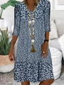 Detail of V-neck neckline on a dark blue floral summer dress with a wooden necklace - S / Tops / Blue