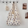 Close-up of floral embroidery texture on cream canvas tote bag with purple flowers - Purple Floral