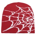 Detailed view of red knitted beanie featuring a white spider web jacquard pattern - One Size / Red & White