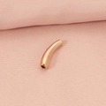 Rose gold curved tube bead jewelry charm for DIY bracelets on pink fabric - Rose Gold Curved Tube Pendant