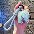 Light blue faux leather letter N keychain featuring a woven strap and lychee texture - Letter N