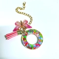 Resin letter O keychain with colorful heart sequins, pink bow, and golden tassel charm - Letter O