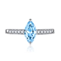 Macro detail of marquise-cut light blue topaz ring with silver band and side zircon stones - Adjustable Open / Blue Zirconia