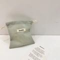 Close-up of small Oxford drawstring bag in light grey-green with woven Sozakka label - Light Gray