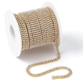 Sparkling gold plated rhinestone claw chain with clear crystals wound on a spool - Gold / White Zirconia / Medium Bulk Roll