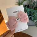 Detailed close-up of a pink cotton bow hair clip featuring a white central emblem on display - Watermelon Pink Bowknot Duckbill Clip