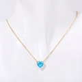 Golden heart necklace with blue birthstone pendant displayed on a white mannequin - December