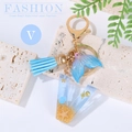 Blue resin letter V keychain with beach sand, starfish, tassel and whale tail charm - Letter V