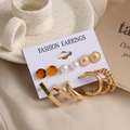 Detailed macro view of 6-pair gold earring set with pearls and resin on a decorative card - Gold Pearl Resin Hoop Set (HZS2094-4)