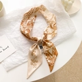 Elegant cream and brown floral silk ribbon scarf tied in a bow on a white backdrop - Letter V-Beige Orange Brown Forest
