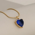 Elegant gold snake chain necklace featuring a vibrant blue heart-shaped crystal pendant - Gold + Blue