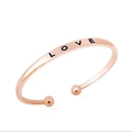 Minimalist rose gold open bangle featuring LOVE engraving and spherical end details - LOVE Letter Engraving / Rose Gold