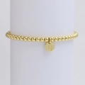 Close-up of golden beaded bracelet featuring a round Q-letter pendant on a white pedestal - Letter Q (DB240603-Q)