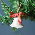 White metal Christmas bell with red plaid bow and berries hanging on a green tree - White Single Trumpet Bell