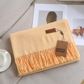 Soft peach-colored cashmere-feel scarf with elegant fringes and brand label - Milky Yellow