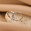 Silver bow ring with round stone and pear-shaped drop pendant on textured stone - Silver Pear Drop Zirconia Ring (2575)