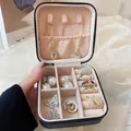 Portable black jewelry box with zipper, featuring beige velvet interior for rings and necklaces - 10x10x5cm / Black
