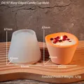Detailed view of wavy silicone mold for candle cups with size measurements and orange candle - D4197 / Wavy Candle Cup Mold