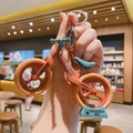Detail of a mini balancing car keychain with Speedy text and a blue base attachment - Orange