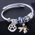 Silver steel wire bangle with angel wings, cat paw enamel charm and black tassel - Black