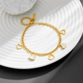 Close-up of golden heart charms with white mother-of-pearl inlays on a bracelet - Heart Bracelet N205
