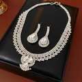 Macro shot of silver crystal waterdrop necklace and earrings set in a black display case - Silver Necklace and Earrings Set