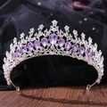 Detailed view of silver crown with teardrop purple crystals and rhinestones on dark wood - Silver & Light Purple (H1130)
