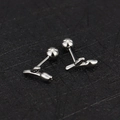 Macro shot of silver tulip stud earrings with screw-on ball back in 16g stainless steel - Tulip / Steel
