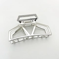 Close-up of silver geometric metal hair claw clip with hollow square design on white background - Silver
