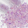 Macro detail of 8mm purple and red speckled glass beads for DIY jewelry on white fur - 10mm Spotted Beads / Fuschia
