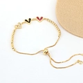 Detail of gold adjustable chain bracelet featuring white, black and pink heart-shaped stones - White/Black/Rose Red (BR10803-10)