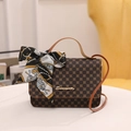 Vintage brown monogram handbag with leather handles and decorative silk scarf detail - Brown