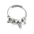 Detail of silver charm bracelet with heart pendant, dragonfly, and sparkling beads - White